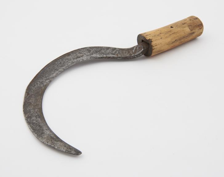 18th century steel sickle with a wooden handle