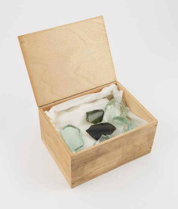 Wood box, lid hinged on adhesive tape, containing bottle-glass