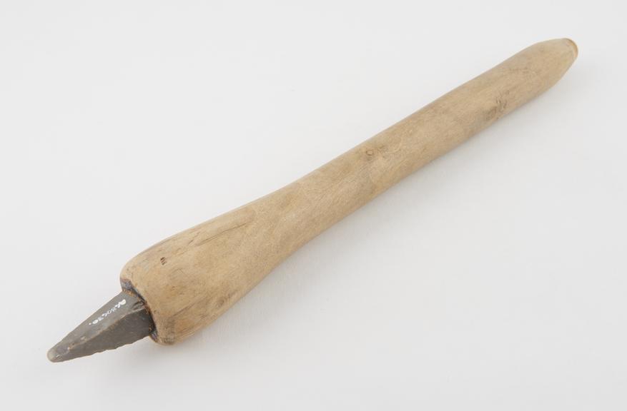 Trephine, bow-drill shaft, wood shaft, embedded flint blade