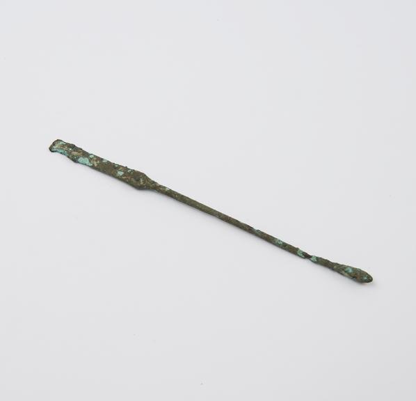 Combined olive-ended probe and spatulae, bronze, encrusted