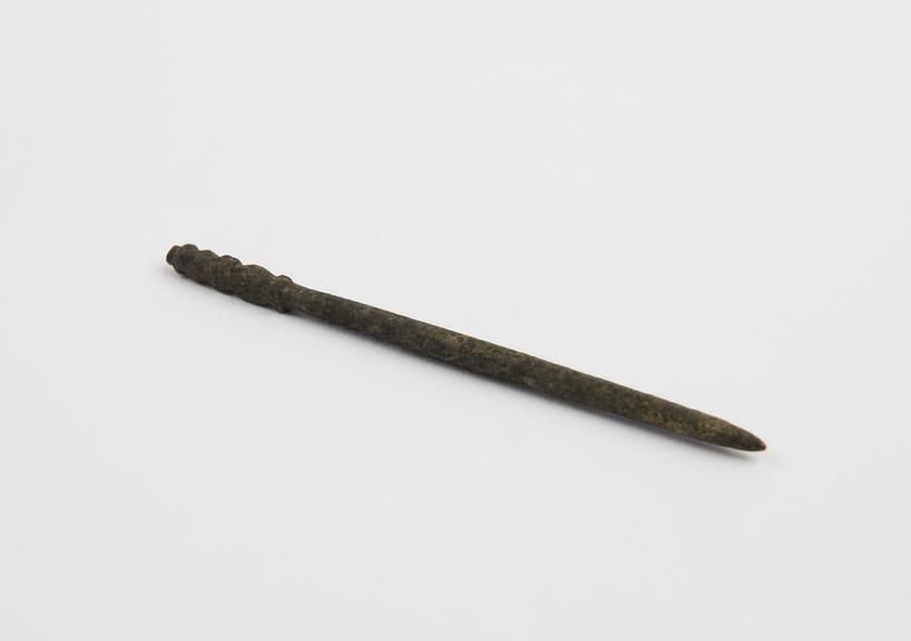 Pin, bronze, with decorated head, date and provenance unknown