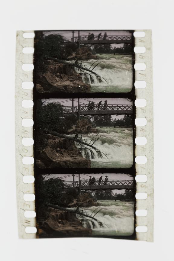 Three frames of silent 35mm Pathecolor positive film showing a