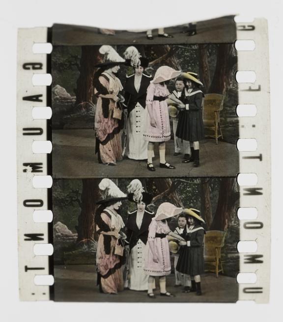 Two frames of silent 35mm stencil colour positive film showing