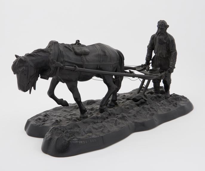 Bronze statuette showing a Russian peasant using a plough