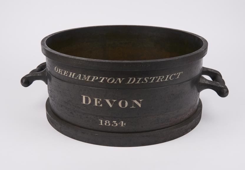 Half bushel measure in bronze inscribed Okehampton District