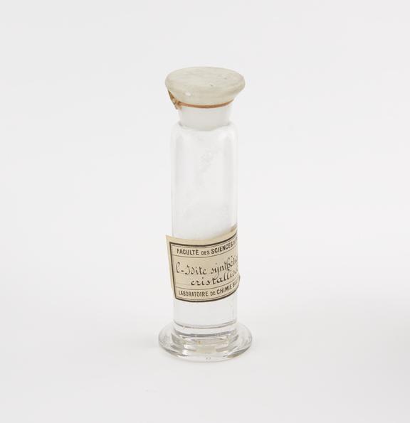 Glass specimen jar containing L-idite synthetique cristallisee