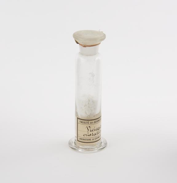 Glass specimen jar containing Vicianose cristallise