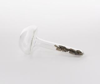 Mushroom shaped glass vial containing praseodymium