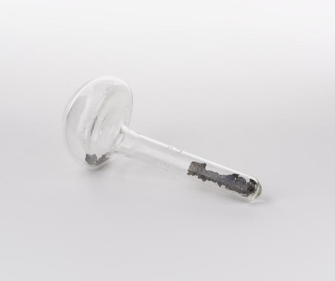 Mushroom shaped glass vial containing europium