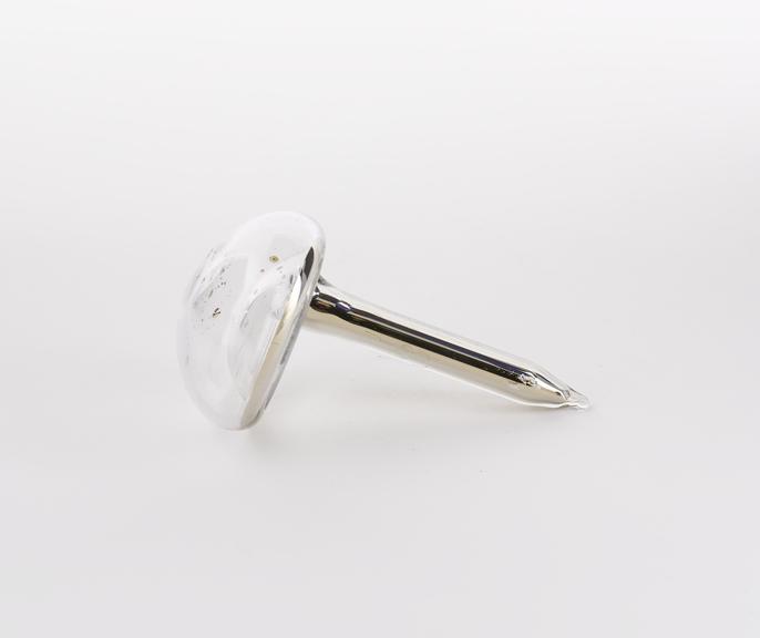 Mushroom shaped glass vial containing caesium, atomic number 55.