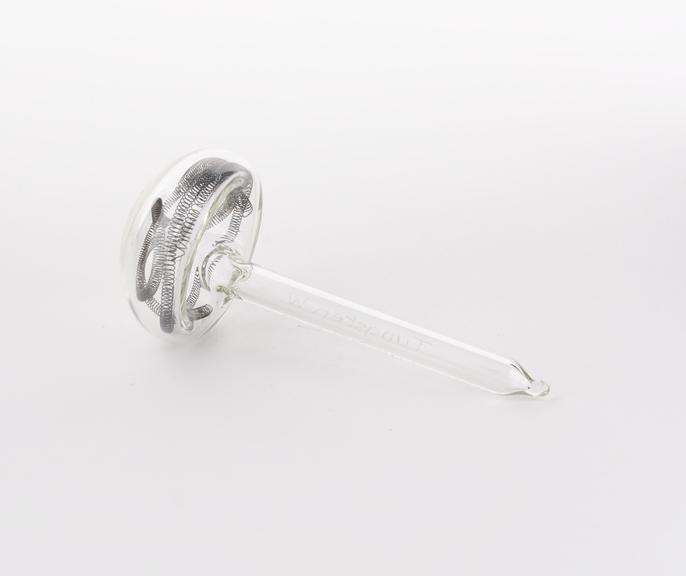 Mushroom shaped glass vial containing tungsten