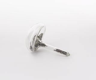 Mushroom shaped glass vial containing calcium