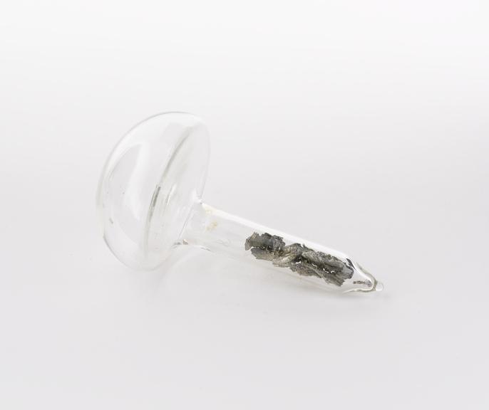 Mushroom shaped glass vial containing scandium