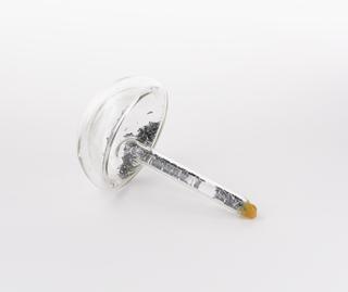 Mushroom shaped glass vial containing beryllium