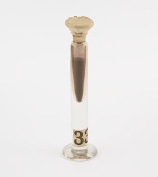 Glass jar containing unidentified specimen