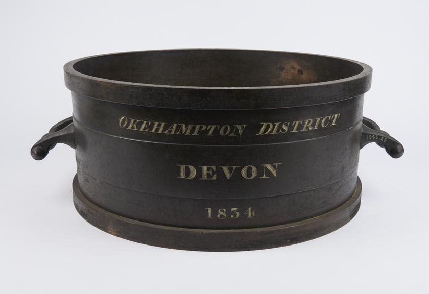 Bushel measure in bronze inscribed Okehampton District Devon