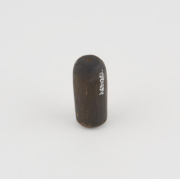 Cylindrical block of wood, possibly instrument handle