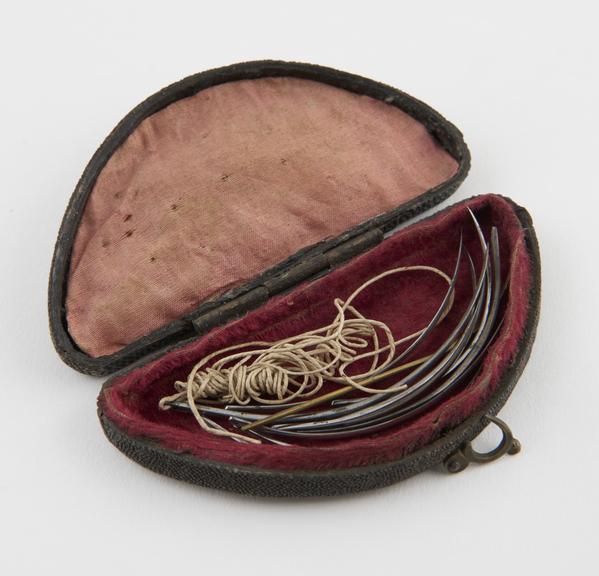 10 suture needles, steel, one with twine, in fishskin case