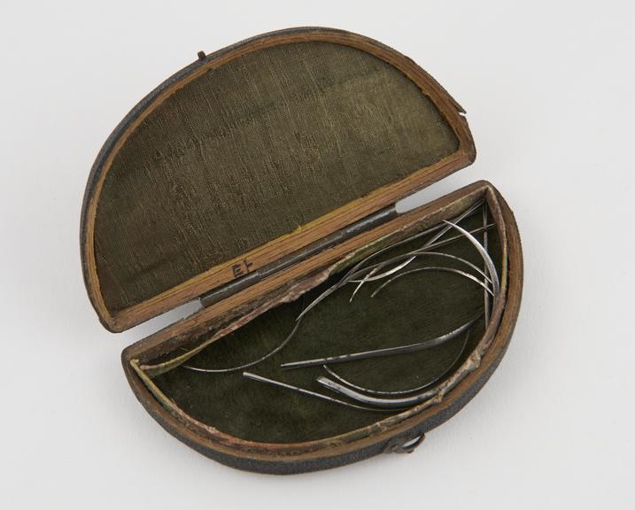 11 suture needles, steel, in fishskin case, 19th century