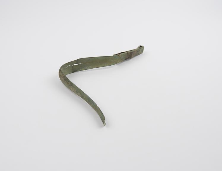 Bronze strigil with curved blade and looped handle