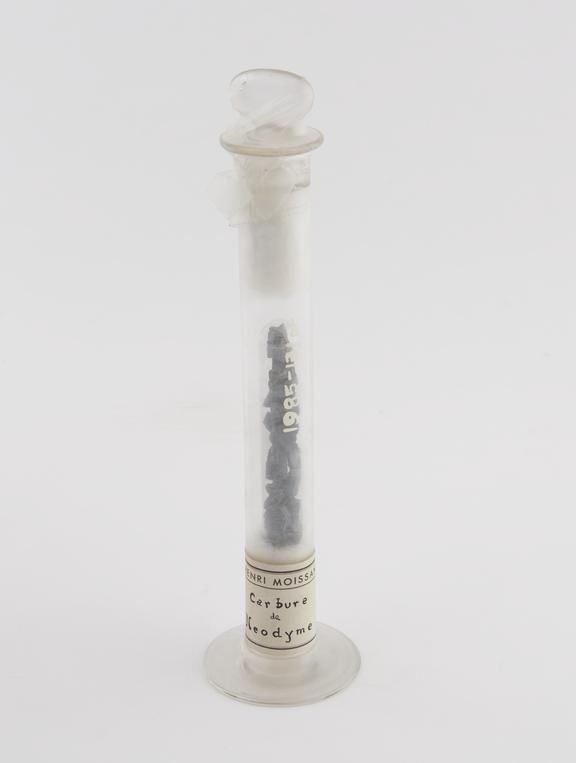 Carbure de neodyme in a tall specimen jar with glass stopper