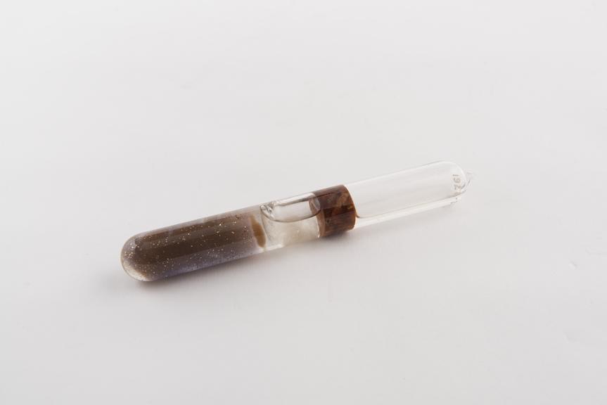 Glass test tube of gold crystals formed in silicic acid gel