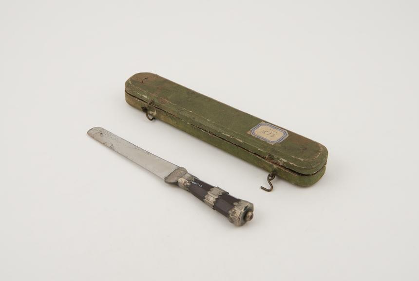 Circumcision knife with steel blade and crude wooden handle