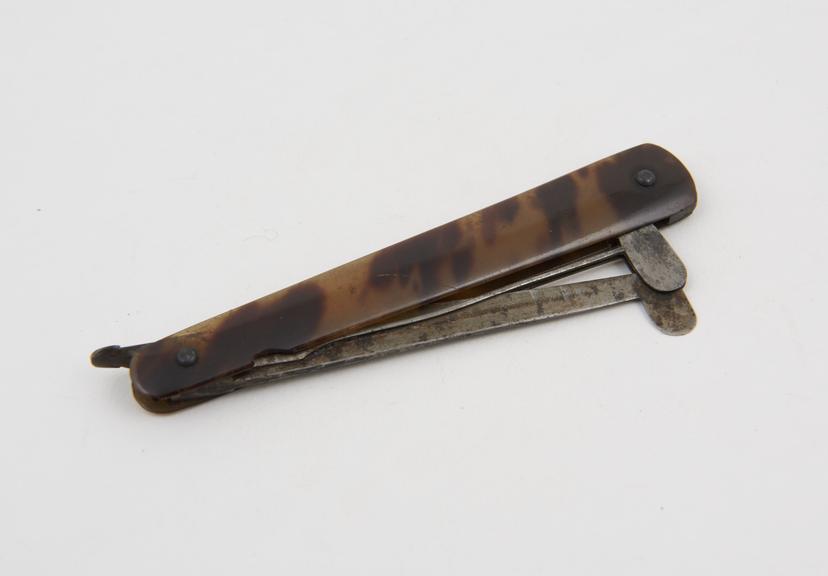 Folding gum lancet with guard and tortoiseshell handle