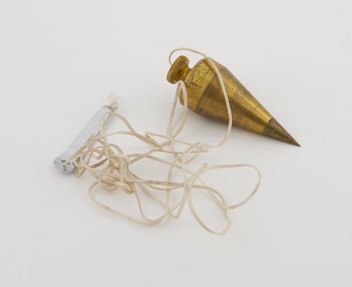 Conical brass plummet, weighted, on cord, 1980s