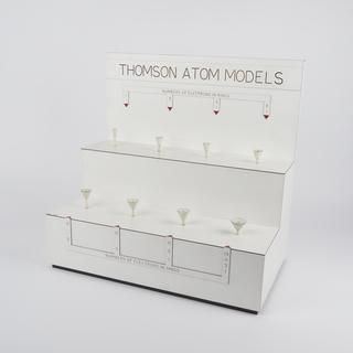 Wooden base with stands for eight Thomson atom models