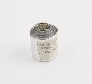 Spool 1 of aluminium rainfall record tape, counted, unsigned, United Kingdom, dated 25 June 1958