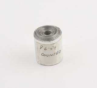 Spool, one of two, of aluminium rainfall record tape, unsigned, United Kingdom, dated 8 June 1959