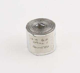 Spool 1 of aluminium rainfall record tape, unsigned, United Kingdom, dated 12 April 1960