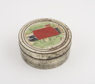 Film cannister containing reel of aluminium rainfall record tape, spools 1 and 2, unsigned, United Kingdom, taken on ascent 1 on 12 January 1965