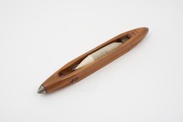 Weaver's shuttle with thread