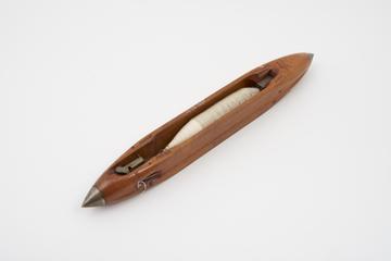 Weaver's shuttle with thread