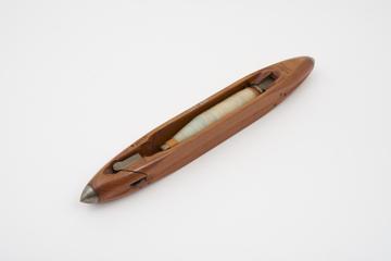 Weaver's shuttle with thread