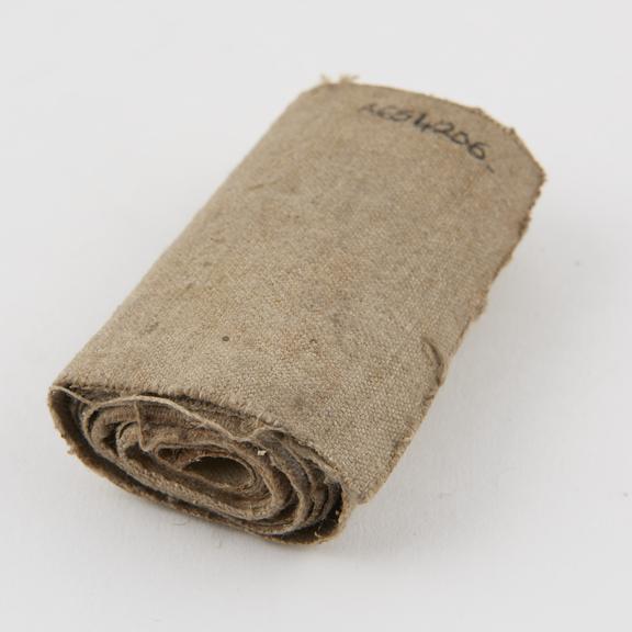 Roll of bandage, canvas with plaster backing, grey