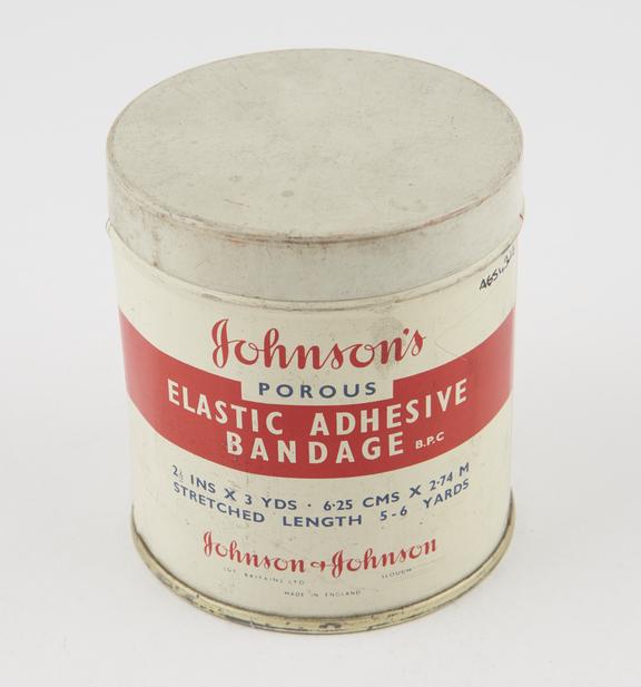 Elastic bandage, wrapped in cellophane, with metal container