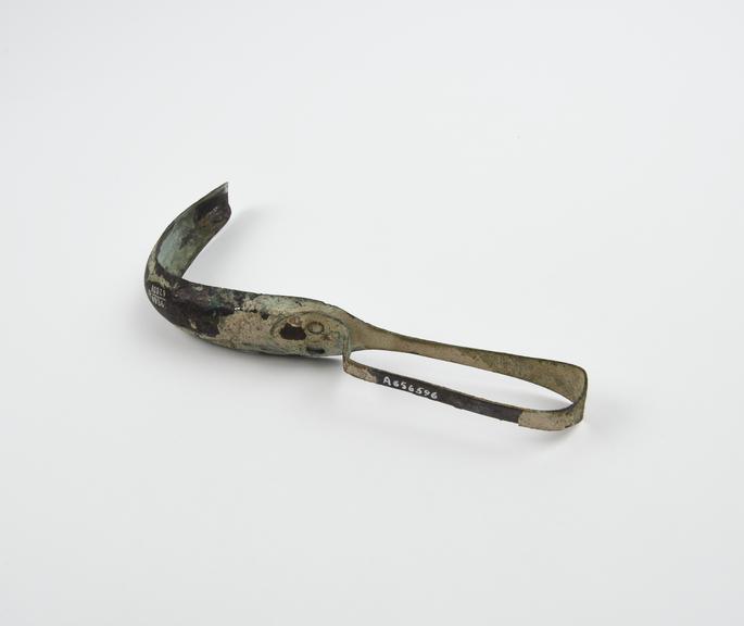 Bronze strigil with curved blade and looped handle, Roman