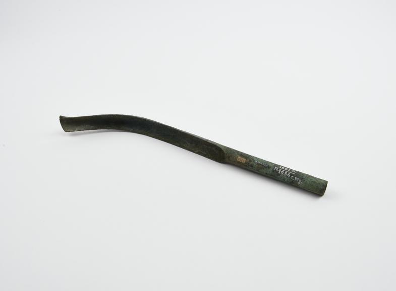 Bronze strigil, curved blade and hollow, cylindrical handle