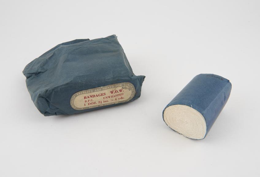 Two rolls of gauze bandage wrapped in blue paper, labelled B.P