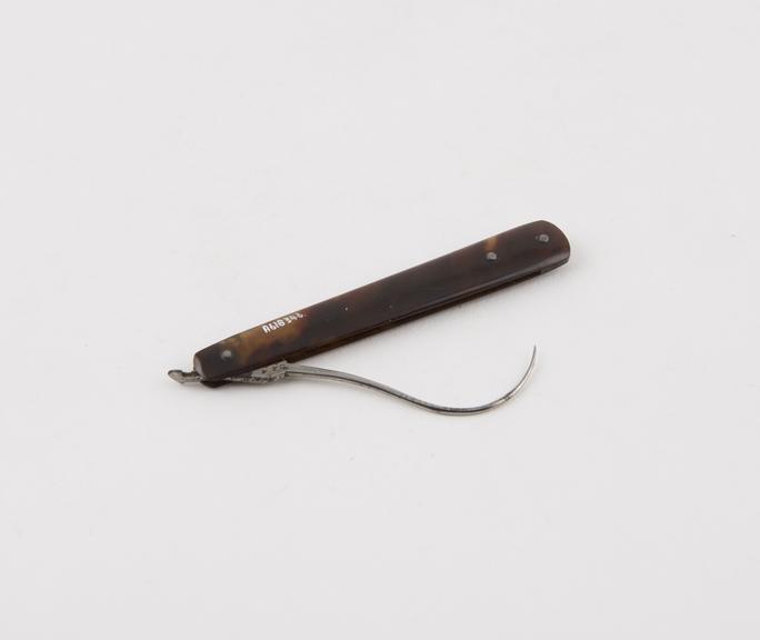 Tenaculum, steel, folding, in tortoiseshell sheath