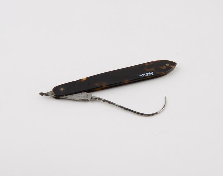 Tenaculum, steel, folding, in tortoiseshell sheath