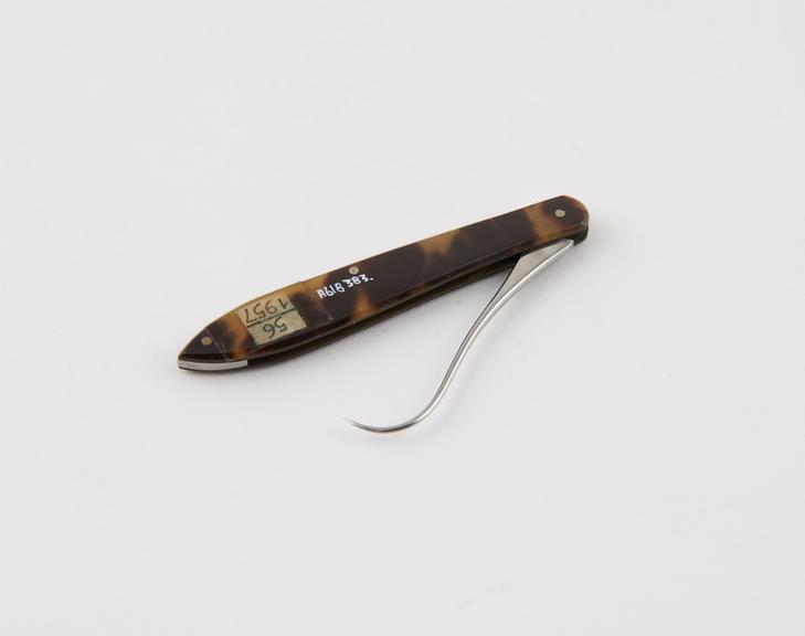 Tenaculum, steel, folding, in tortoiseshell sheath