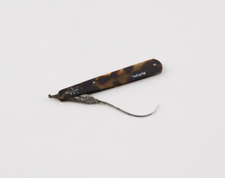 Tenaculum, steel, folding, in tortoiseshell sheath
