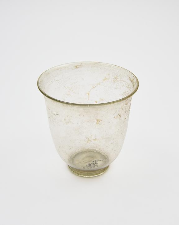 Glass cup, colourless, sides tapering to base, everted rim