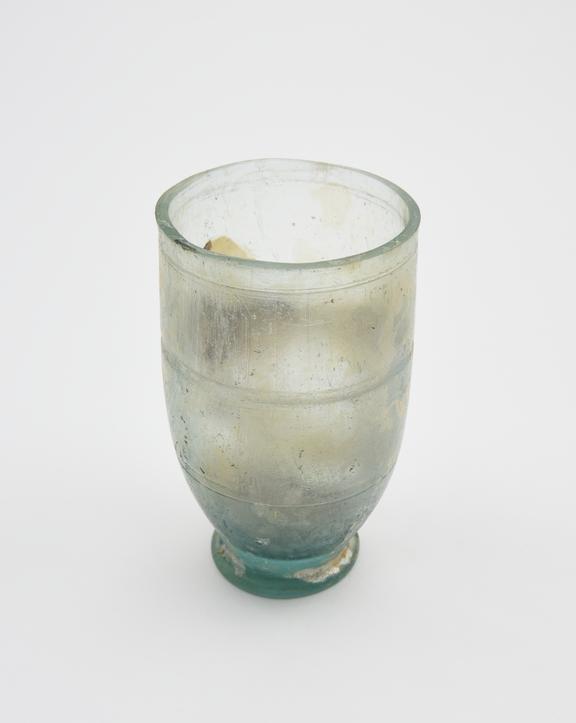 Glass cup, green, with wheel cut lines, Roman, 1 to 100 AD