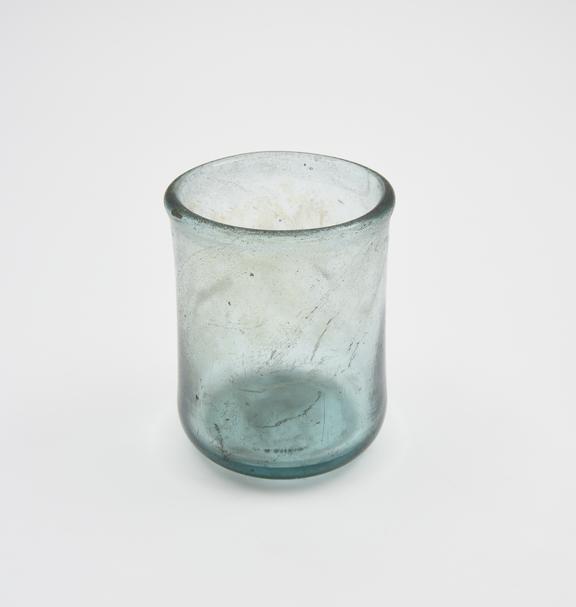 Glass cup, heavy, dark green, straight sides, thickened rim