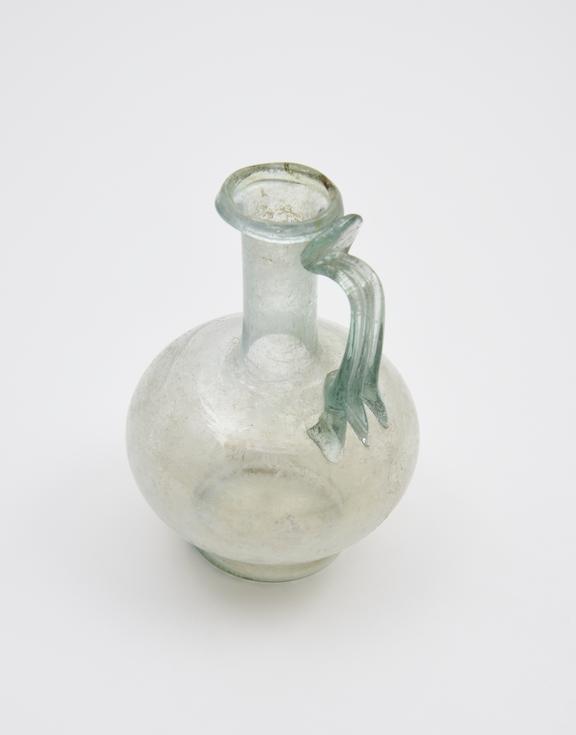 Glass jug, pale green, with squat bulbous body